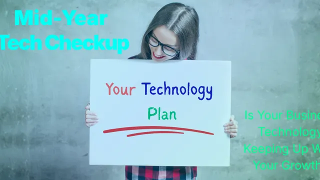 A business owner reviewing technology performance on a whiteboard, representing mid-year technology planning for small businesses in North Carolina and Virginia.