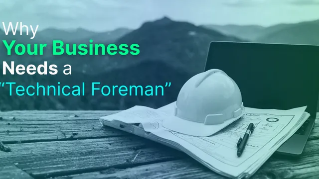 A pair of blueprints and a hard hat resting on a laptop, symbolizing the blend of construction management and technology.