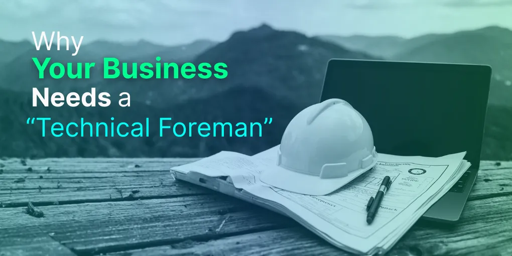 A pair of blueprints and a hard hat resting on a laptop, symbolizing the blend of construction management and technology.